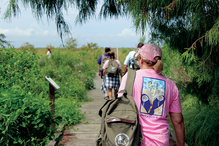 Participants walk through wetlands at Turtle Cove Environmental Research Station (Turtle Cove ERS) on Pass Manchac in southeastern Louisiana.